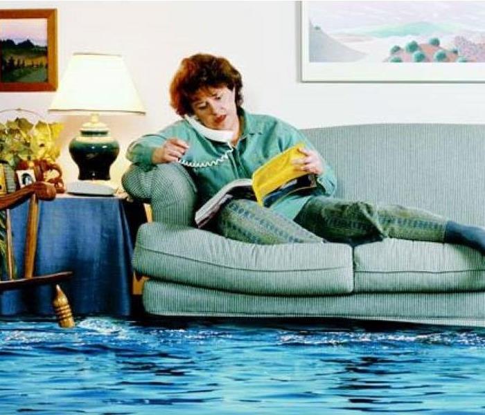 woman on couch with flooding water